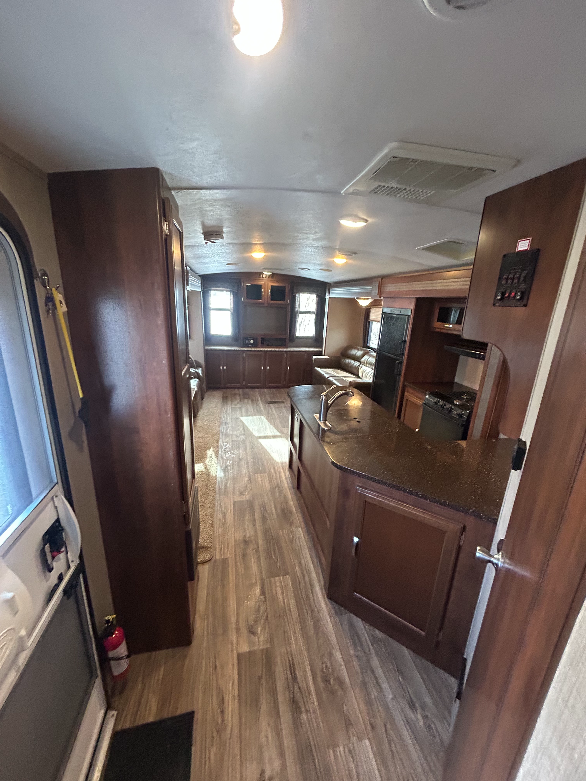 2015 Keystone Passport Elite 31RE travel trailer view of entrance door leading to kitchen and living space