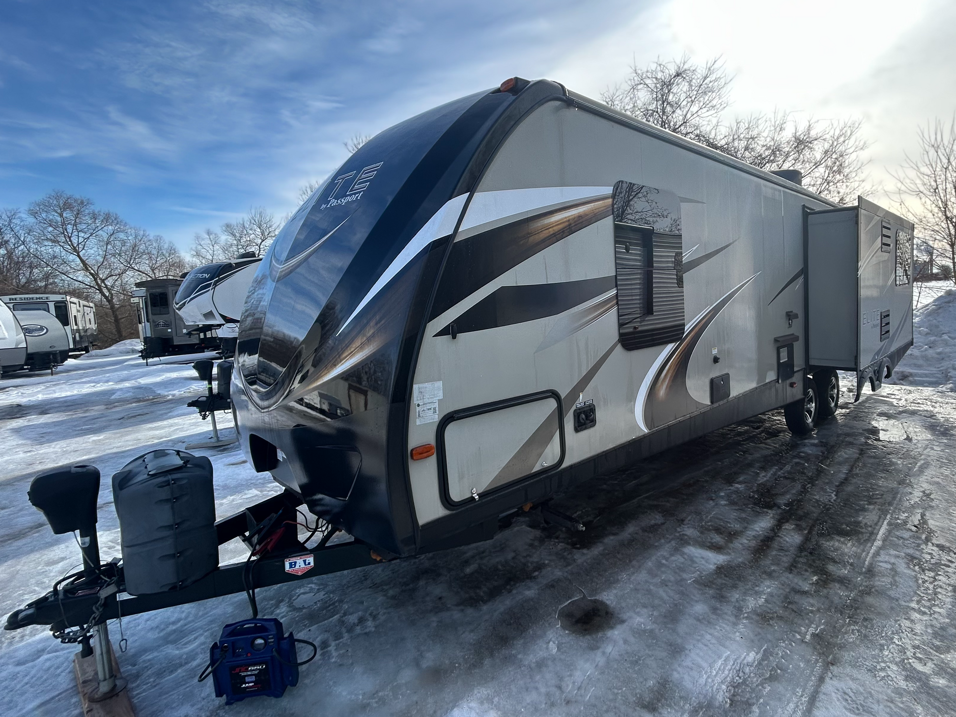 2015 Keystone Passport Elite 31RE travel trailer showing exterior and second slideout